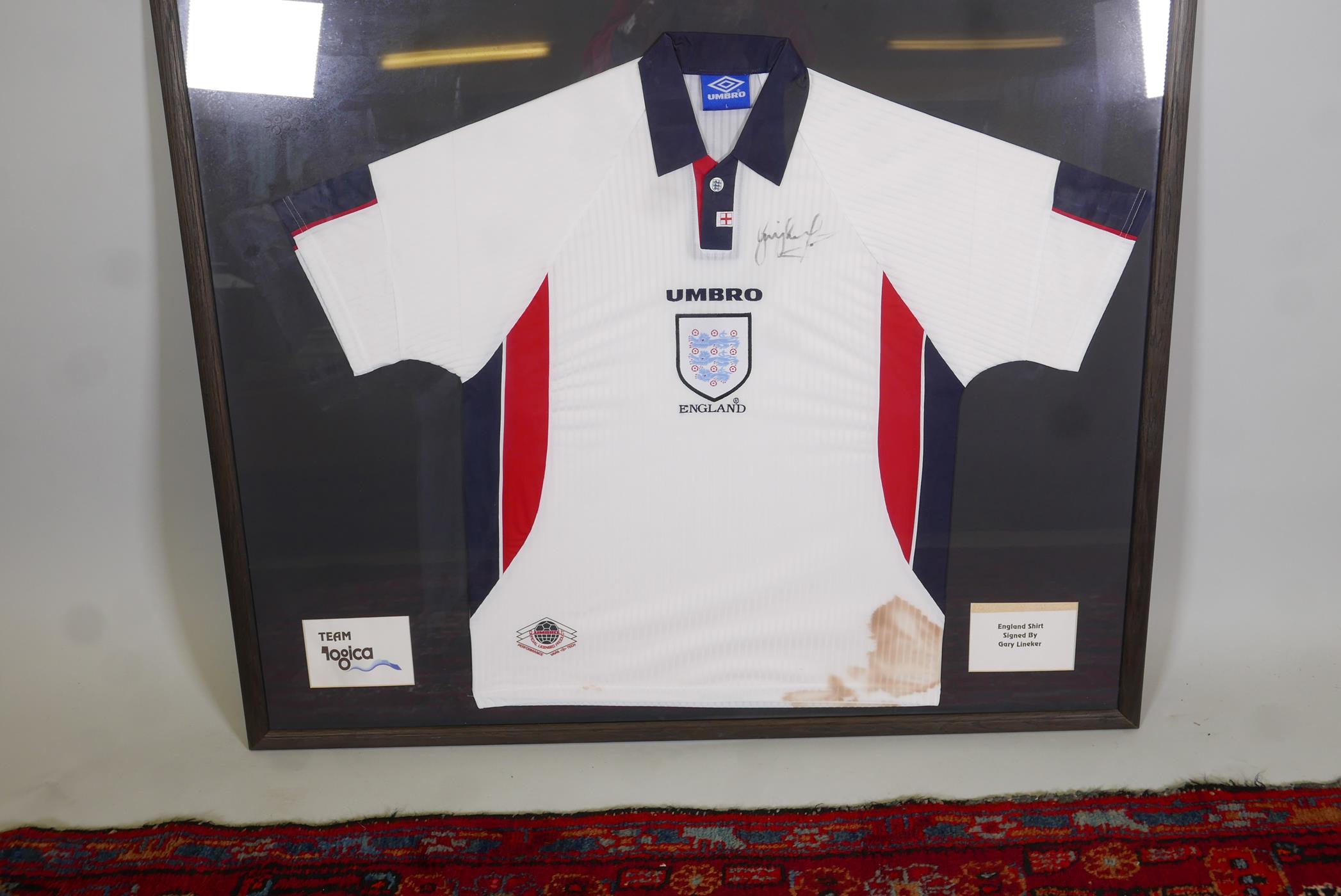 A framed 1998 England World Cup football shirt, purportedly signed by Gary Lineker. 44" x 37"