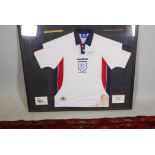 A framed 1998 England World Cup football shirt, purportedly signed by Gary Lineker. 44" x 37"