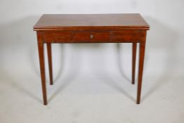 A Georgian III tea table with a fold over top and a single drawer, raised on square tapering