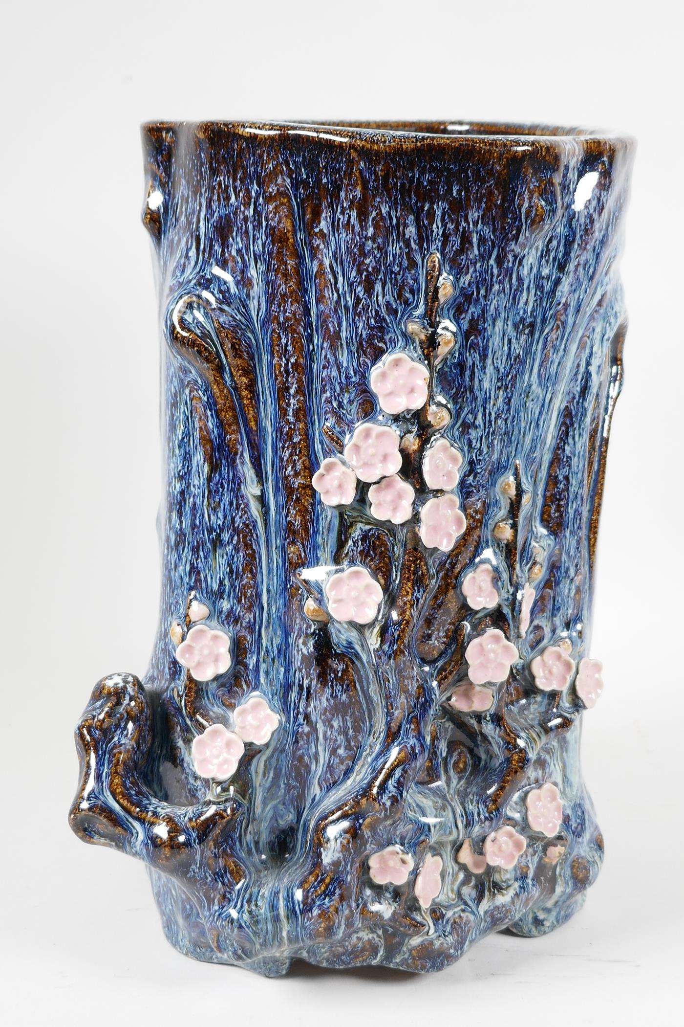 An Oriental stoneware vase, formed as a tree trunk with embossed prunus blossom, on a flambe - Image 2 of 5