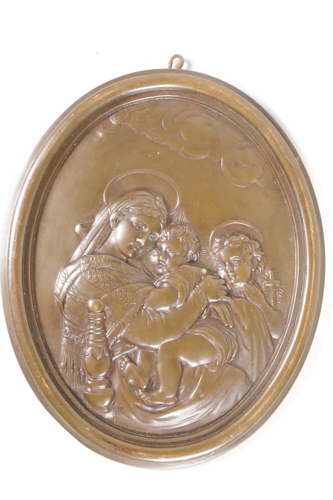 An embossed oval bronze plaque, depicting 'The Madonna, Jesus and St John, 5" x 6"