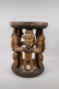 An African carved & stained wood figural stool. 16½" high x 12" diameter