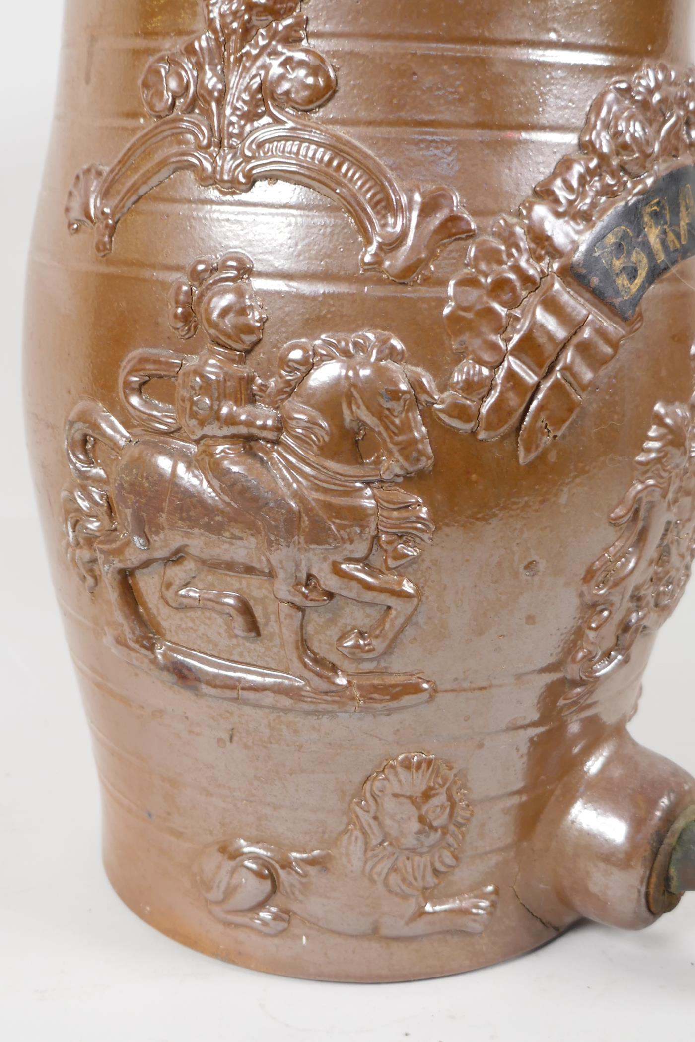 A C19th salt glazed stoneware brandy barrell, embossed with figures of knights on horseback, lions - Image 3 of 4
