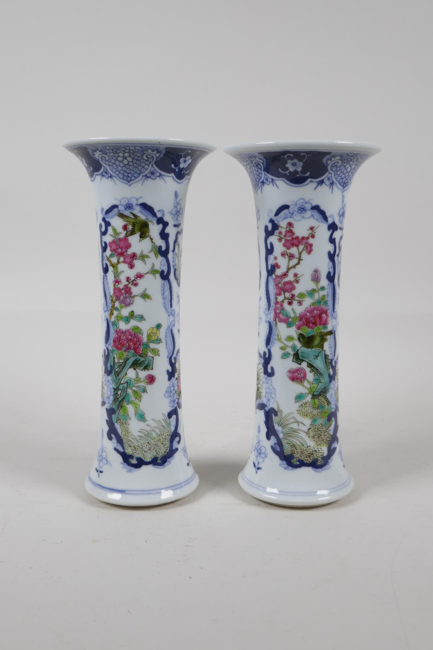A pair of early C20th Chinese blue and white porcelain stem vases with decorative famille verte