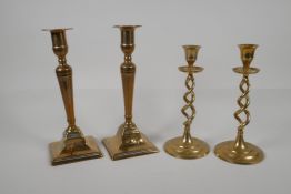 A pair of brass candlesticks with pierced spiral stems and another pair of candlesticks, largest 9½"