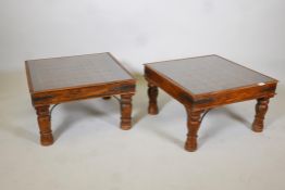 A pair of Indian iron bound occassional tables, on turned supports. With brass mounted  tops,