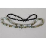A jade bead necklace, 21½" long, together with a faceted french jet bead necklace, 16" long