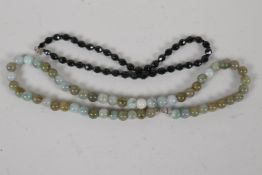 A jade bead necklace, 21½" long, together with a faceted french jet bead necklace, 16" long