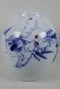 An Oriental blue and white porcelain vase of bulbous form, with painted decoration of flowers, 11"