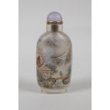 A Chinese reverse decorated glass snuff bottle depicting figures in a river landscape, and scribes
