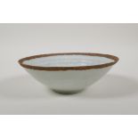 A Song style celadon glazed conical porcelain bowl, with underglaze figural and floral decoration
