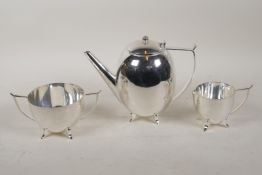 An Arts & Crafts style three piece electroplated tea set, 6½" high