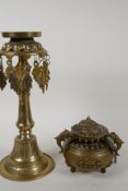 A Tibetan brass oil lamp stand, 11" high, and a cast brass swinging censer