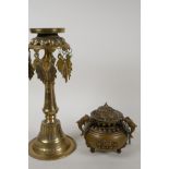 A Tibetan brass oil lamp stand, 11" high, and a cast brass swinging censer