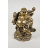 A Chinese filled and polished bronze figure of a jolly Buddha, 10½" high