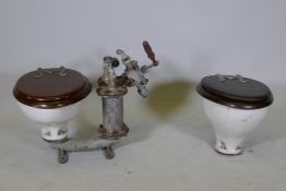 Two vintage porcelain sea toilets by Blake & Sons of Gosport, one with an attached period pump