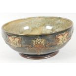 A Royal Doulton stoneware fruit bowl with embossed garland design on a green glaze, 9½" diameter