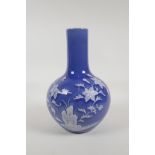 A blue glazed porcelain vase with white enamelled floral decoration, Chinese Qianlong seal mark to