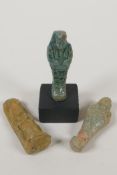 Two Egyptian turquoise glazed faience shabtis, together with a pottery token in the form of a seated