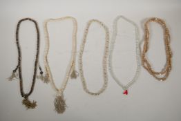 Two strings of Tibetan bone mala beads, and three strings of prayer beads, longest 44"