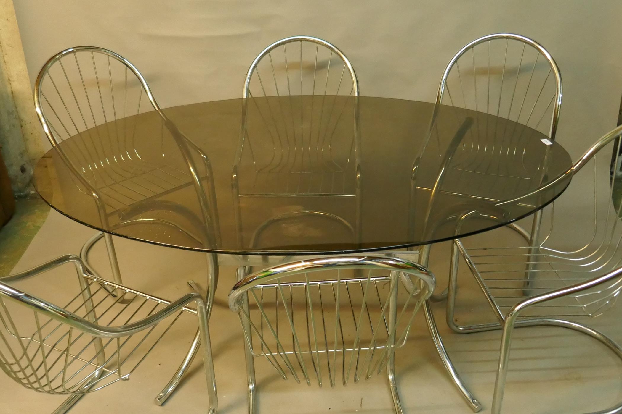 A chrome and tinted glass top dining table and six chairs ensuite, 65" x 42" x 30"