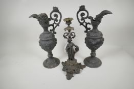 A spelter candlestick cast as a classical muse, 13" high, and a pair of ornamental spelter ewers