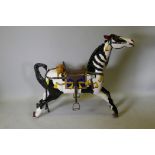 An early C20th carved and painted black and white carousel horse, 46" long, 40½" high