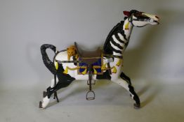 An early C20th carved and painted black and white carousel horse, 46" long, 40½" high