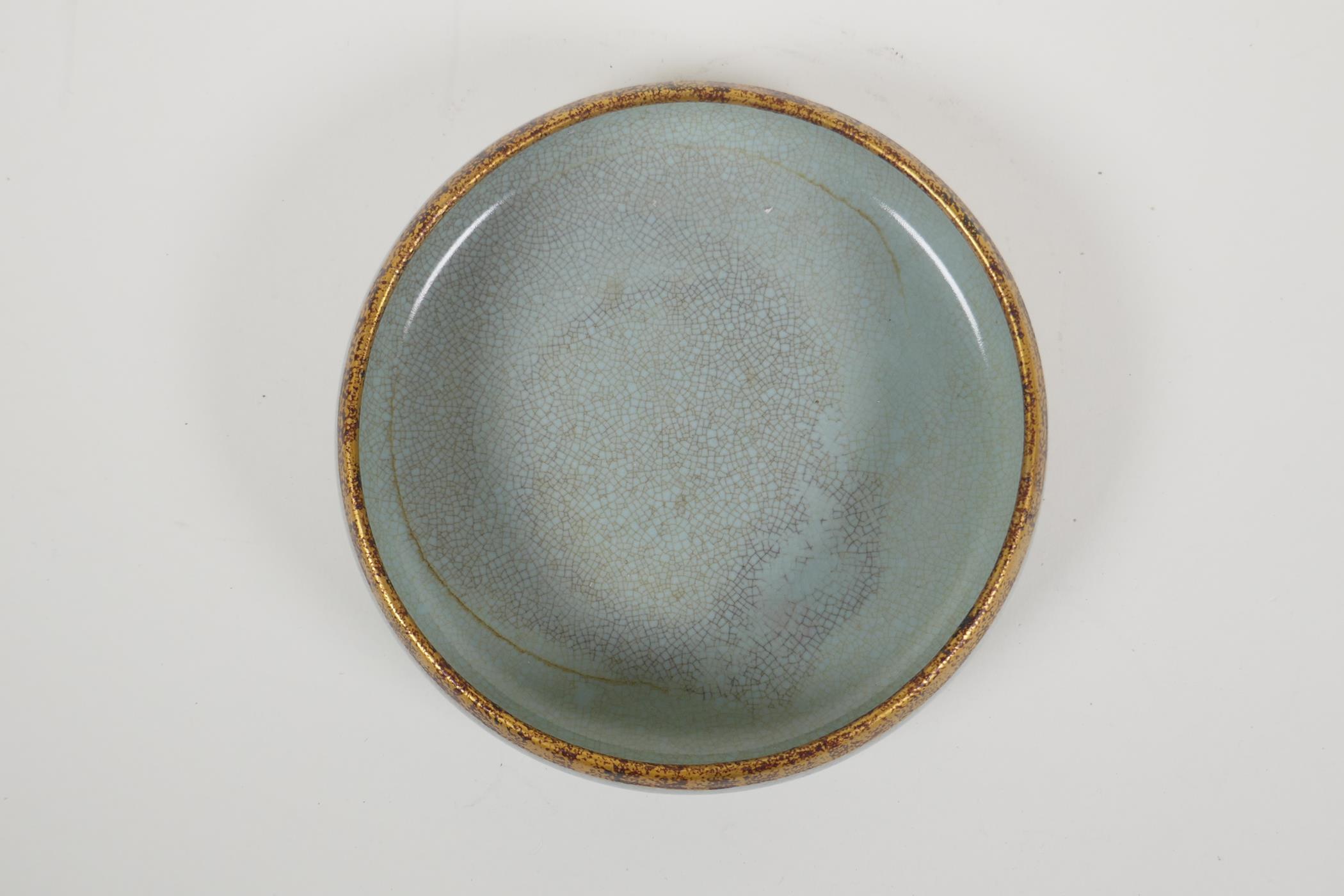 A celadon crackle glazed Ru ware style porcelain dish with a gilt metal rim, the base with - Image 2 of 3