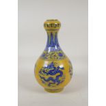 A Ming style yellow ground porcelain garlic head shaped vase with blue and white dragon