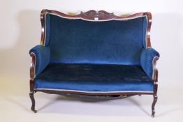 A Victorian carved mahogany wing back two seater settee, 53" wide, 39" high