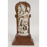 A C19th finely carved Indian ivory figure of Shiva, mounted on a rosewood base, 10" high