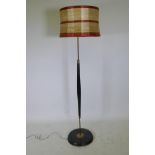 A mid-century ebonised wood and brass mounted standard lamp, 55" high