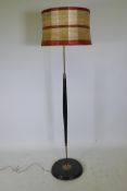 A mid-century ebonised wood and brass mounted standard lamp, 55" high