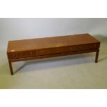 A mid century teak low table with three push/pull drawers, 59" x 18" x 16"
