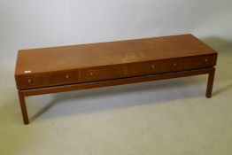 A mid century teak low table with three push/pull drawers, 59" x 18" x 16"