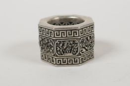 A Chinese white metal archers thumb ring with pierced floral panels, impressed character mark to