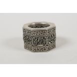 A Chinese white metal archers thumb ring with pierced floral panels, impressed character mark to