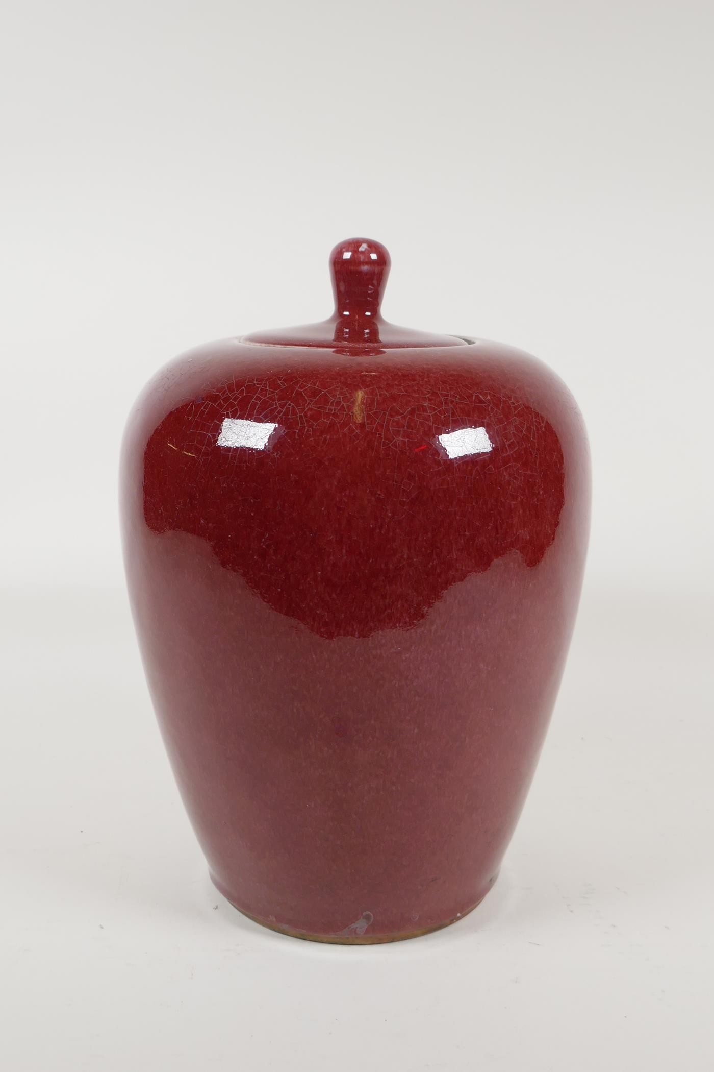 A Chinese iron red glazed porcelain jar and cover, 10½" high