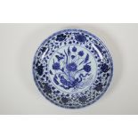 A Chinese blue and white porcelain charger with floral decoration, 6 character mark to base, 11"