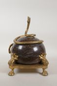 An ormolu and serpentine ball centrepiece with a coiled serpent mount, 8" x 8", 12" high