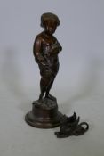 A bronze mount in the form of a griffin, 4" long, and a brass figure of a cherub, 15" high