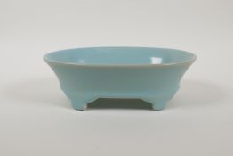 A Chinese Ru ware style porcelain dish of oval form, raised on four supports, 8" x 5½"