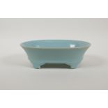 A Chinese Ru ware style porcelain dish of oval form, raised on four supports, 8" x 5½"