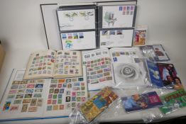 Three albums of World stamps, an album of eighty first day covers, and a quantity of Royal