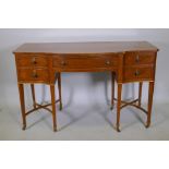 A C19th satinwood five drawer kneehole desk, with serpentine front and canted corners, raised on