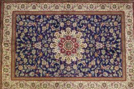 A full pile blue ground Kashmir carpet with a shabaz medallion design and cream borders, 46" x 68"