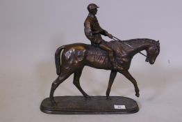 After O. Tupton, cold cast bronzed figure of a jockey and mount, 14½" high