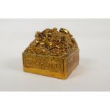 A Chinese filled gilt bronze seal, the top decorated with entwined dragons, 4" x 4"