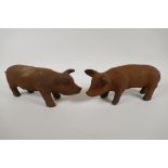 A pair of cast iron garden figures of piglets, 11" long